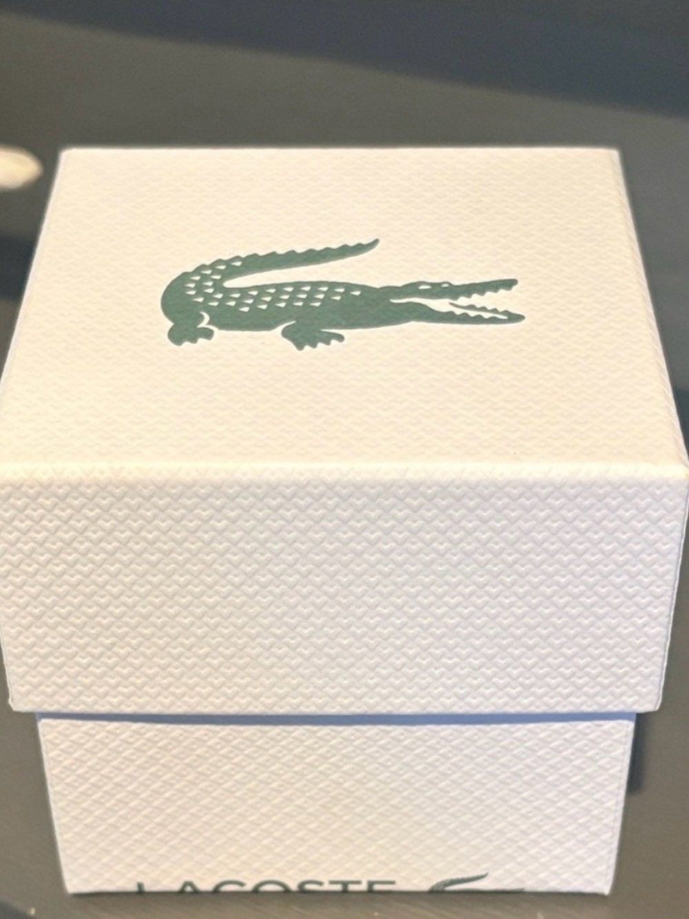 Movado White Box with Black Text, Logos & Mini Lacoste Designer Pillow